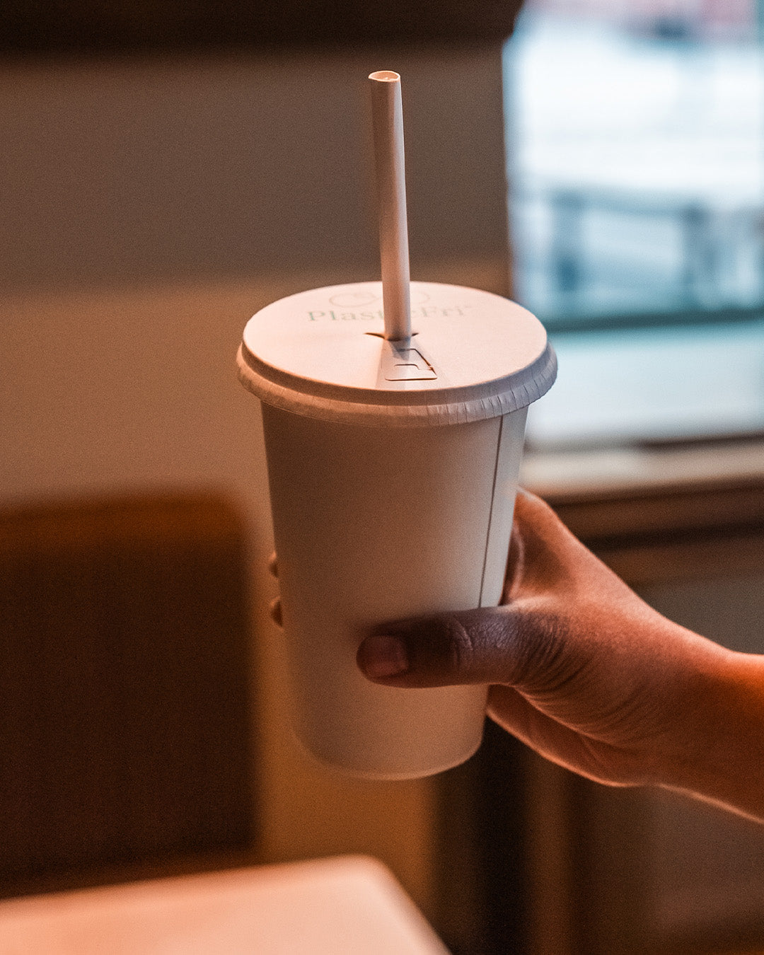 Grale Disposable 16oz Cup, Lifestyle with Straw and Lid